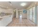 Spacious living area with tile flooring, leading into the kitchen and other rooms at 585 Khyber Ln, Venice, FL 34293