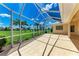 Spacious covered patio with views of the golf course and lush landscaping at 585 Khyber Ln, Venice, FL 34293