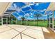 Large screened-in lanai with golf course view, perfect for entertaining at 585 Khyber Ln, Venice, FL 34293