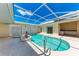 Screened-in pool and lanai area with mature landscaping for privacy and enjoyment at 585 Khyber Ln, Venice, FL 34293