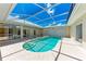 Backyard featuring a sparkling pool, covered lanai and screened enclosure, perfect for Florida living at 585 Khyber Ln, Venice, FL 34293