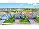An aerial view of three homes and their manicured lawns, set against a serene backdrop of a community lake at 6203 Grandview Hill Ct, Bradenton, FL 34203