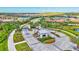 Aerial view of a gated community featuring houses with colorful roofs and lush landscaping at 6203 Grandview Hill Ct, Bradenton, FL 34203
