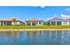 Exterior of homes overlooking the lake, with well-manicured lawns, adding to the home's curb appeal at 6203 Grandview Hill Ct, Bradenton, FL 34203