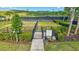 Community bark park with secure fencing, landscaping, and a paved entrance for residents and their pets at 6203 Grandview Hill Ct, Bradenton, FL 34203