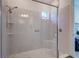 Modern bathroom featuring a glass-enclosed shower, tiled walls, and a convenient built-in shower seat at 6203 Grandview Hill Ct, Bradenton, FL 34203