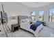 Bright bedroom with large windows, stylish furnishings, and white marble flooring create a welcoming atmosphere at 6203 Grandview Hill Ct, Bradenton, FL 34203