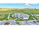 Aerial view of the community clubhouse with lush landscaping, parking, and rolling green hills at 6203 Grandview Hill Ct, Bradenton, FL 34203