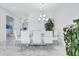This light-filled dining room features a glass-top table, contemporary chairs, and a modern chandelier above at 6203 Grandview Hill Ct, Bradenton, FL 34203