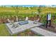 Community fire pit area with Adirondack chairs and a paver patio with landscape views at 6203 Grandview Hill Ct, Bradenton, FL 34203