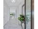 The light-filled foyer features gleaming marble floors and decorative mirror, creating an elegant and welcoming entrance at 6203 Grandview Hill Ct, Bradenton, FL 34203
