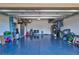 Spacious garage with blue epoxy floors, ample storage, and a clean, organized space at 6203 Grandview Hill Ct, Bradenton, FL 34203