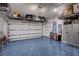 Spacious garage with epoxy floors, plenty of storage shelves and a high ceiling at 6203 Grandview Hill Ct, Bradenton, FL 34203