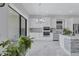 Modern white kitchen with stainless steel appliances, sleek countertops, and stylish mosaic backsplash at 6203 Grandview Hill Ct, Bradenton, FL 34203