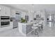 Stylish kitchen with white cabinets, stainless steel appliances, a center island and marble floors at 6203 Grandview Hill Ct, Bradenton, FL 34203