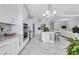 Open kitchen featuring white cabinets, stainless steel appliances, a center island and dining space at 6203 Grandview Hill Ct, Bradenton, FL 34203