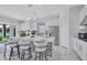 Modern kitchen features a spacious island with seating, sleek white cabinetry, and stainless steel appliances at 6203 Grandview Hill Ct, Bradenton, FL 34203