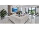 This stylish living area features marble flooring, a modern entertainment center, comfortable seating, and verdant plants at 6203 Grandview Hill Ct, Bradenton, FL 34203