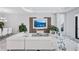 Inviting living room featuring a plush white sectional sofa, modern decor, and a large wall-mounted television at 6203 Grandview Hill Ct, Bradenton, FL 34203