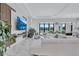 Bright living room with marble floors, modern wall decor, and a view of the landscaped backyard at 6203 Grandview Hill Ct, Bradenton, FL 34203