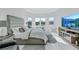 Tranquil main bedroom with water views, large windows, modern decor, and comfortable furnishings at 6203 Grandview Hill Ct, Bradenton, FL 34203
