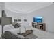 Well-lit main bedroom with a TV on a stand, many pillows, and a large window overlooking the water at 6203 Grandview Hill Ct, Bradenton, FL 34203