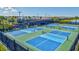 Overhead view of several outdoor pickleball courts surrounded by greenery and neighborhood homes at 6203 Grandview Hill Ct, Bradenton, FL 34203