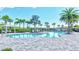 Community pool featuring lounge chairs, palm trees, cabanas, and a gray brick pool deck at 6203 Grandview Hill Ct, Bradenton, FL 34203