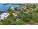 Aerial view of a waterfront property with a pool, lush landscaping, and direct access to the bay at 6343 Hollywood Blvd, Sarasota, FL 34231