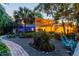 Landscaped backyard with lush tropical vegetation, covered patio, and stone walkway at 6343 Hollywood Blvd, Sarasota, FL 34231