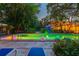 Backyard pool with a patio area, lounge chairs, tropical landscaping, and colorful lighting at 6343 Hollywood Blvd, Sarasota, FL 34231