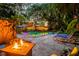 Inviting backyard with a large pool, fire pit, patio, lounge chairs, and lush, tropical landscaping at 6343 Hollywood Blvd, Sarasota, FL 34231