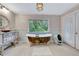 This bathroom features a clawfoot tub with a beautiful garden window, plus modern vanity at 6343 Hollywood Blvd, Sarasota, FL 34231