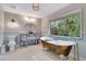 This bathroom features a clawfoot tub, a vanity mirror, and a view to the exterior at 6343 Hollywood Blvd, Sarasota, FL 34231