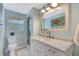 Well-lit bathroom featuring a large mirror, vanity with marble countertop, and a walk-in shower at 6343 Hollywood Blvd, Sarasota, FL 34231