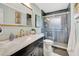 Updated bathroom featuring a vanity with marble countertop, a walk-in shower, and a mirror with a decorative frame at 6343 Hollywood Blvd, Sarasota, FL 34231