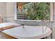 The clawfoot bathtub has views of the tropical foliage outside the bathroom window at 6343 Hollywood Blvd, Sarasota, FL 34231