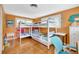 Bedroom with bunk beds, two windows with shutters, and hardwood floors at 6343 Hollywood Blvd, Sarasota, FL 34231