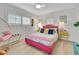 Bright bedroom featuring wood floors, two windows with shutters, a ceiling fan and colorful furniture at 6343 Hollywood Blvd, Sarasota, FL 34231