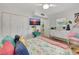 Bright bedroom featuring wood floors, white closet doors and colorful furniture at 6343 Hollywood Blvd, Sarasota, FL 34231
