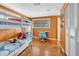 Bedroom with bunk beds, window with colorful panes, and hardwood floors at 6343 Hollywood Blvd, Sarasota, FL 34231