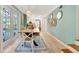 Dining room with long wooden table, adjacent to kitchen, with bright blue accent wall and white trim at 6343 Hollywood Blvd, Sarasota, FL 34231