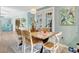 Dining room with long wooden table, adjacent to kitchen, with bright blue accent wall at 6343 Hollywood Blvd, Sarasota, FL 34231