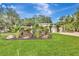 Charming home with lush landscaping, mature trees, and a well-manicured lawn, exuding curb appeal at 6343 Hollywood Blvd, Sarasota, FL 34231