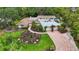 Beautiful home showcasing lush landscaping, brick driveway, and charming curb appeal at 6343 Hollywood Blvd, Sarasota, FL 34231