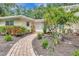 Inviting front entrance featuring a brick walkway and lush landscaping at 6343 Hollywood Blvd, Sarasota, FL 34231