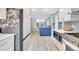 Open-concept kitchen with stainless refrigerator and appliances plus a blue island at 6343 Hollywood Blvd, Sarasota, FL 34231