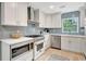 Bright kitchen with white cabinetry, stainless appliances, light countertops, and a decorative backsplash at 6343 Hollywood Blvd, Sarasota, FL 34231