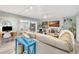 Spacious living room with tan leather sectional sofa, and decorative fireplace at 6343 Hollywood Blvd, Sarasota, FL 34231