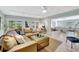 Spacious living room with tan leather sectional sofa, ceiling fan, and access to an office at 6343 Hollywood Blvd, Sarasota, FL 34231